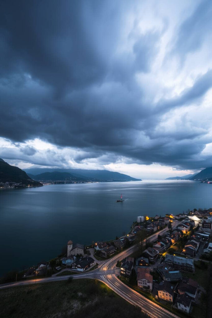 photograph of Lugano, Switzerland, depicting stormy skies, light trails, and high tension